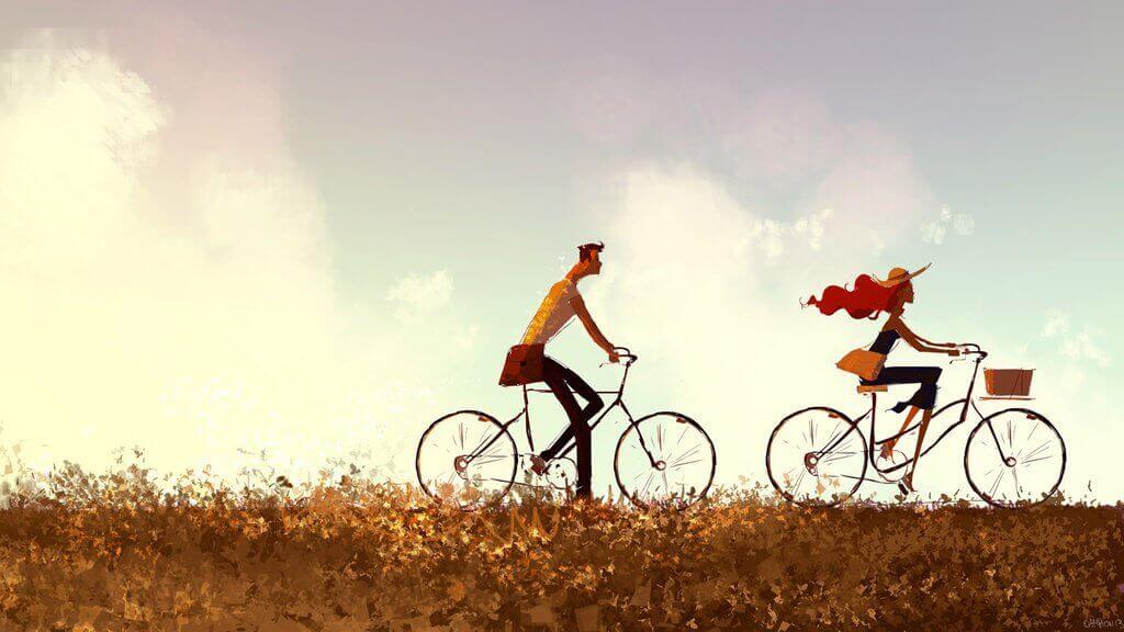 Nainen ja mies nauttivat pyöräilystä