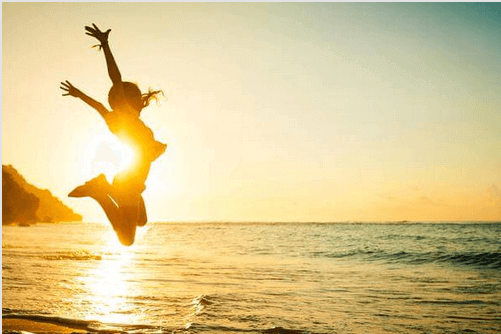 Tyttö nauttii nykyhetkestä rannalla