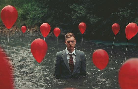 mies ja ilmapallot joessa
