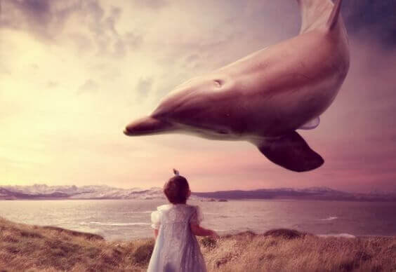 tyttö ja lentävä delfiini
