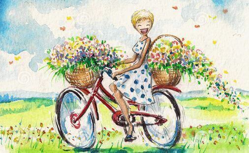 nainen pyöräilee kukkien kanssa