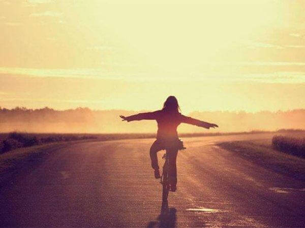 tyttö ajaa pyörää ilman käsiä