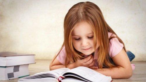 pieni tyttö lukee kirjaa